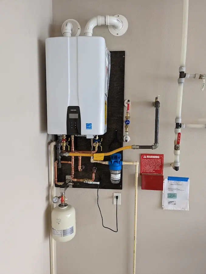 Professional plumber installing copper piping in a Paloma Creek home